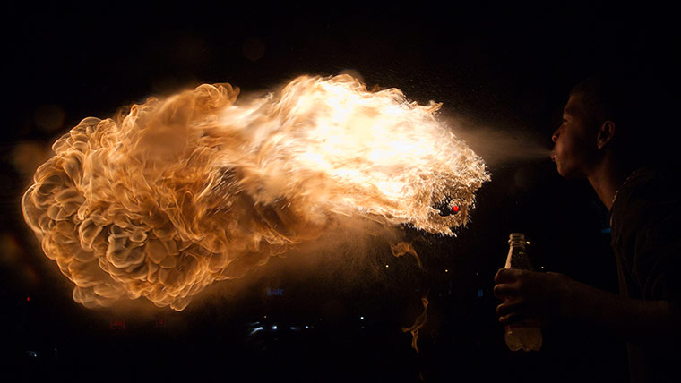 24 hours: Ecuadorean busker Cristian Arroyo, 16, breathes fire along a street in Quit