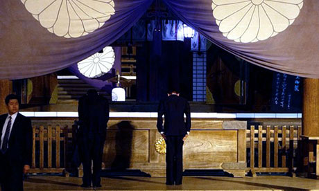 Taro Aso, Japan's deputy prime minister and finance minister, bows at the Yasukuni shrine in Tokyo