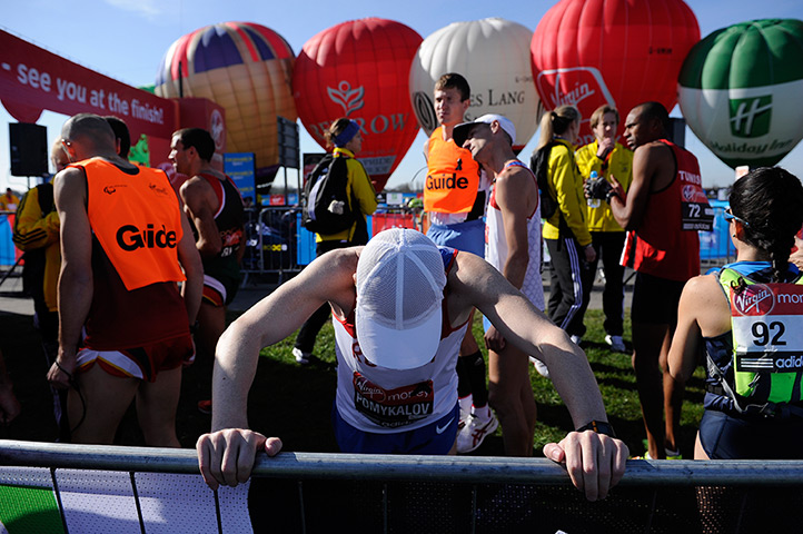 London Marathon: a runner in the blind section of the paralympic race warms up on Blackheath