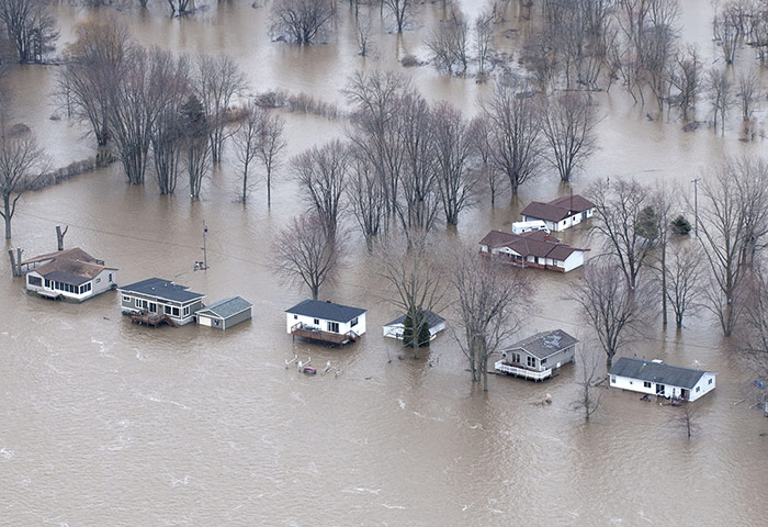 24 hours in pictures (2): Flood waters envelop a town in Michigan