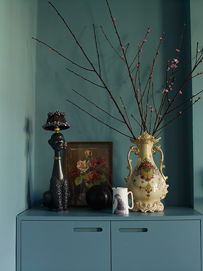 homes - lou rota: two vases on a blue chest of drawers against a blue/green wall