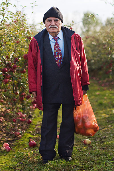 big picture - what ali : man with apples in red coat and suit and hat