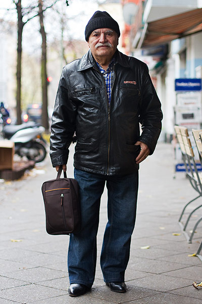big picture - what ali : man in black jacket, hat and holding bag in street