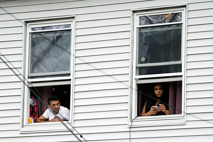 Boston bombings timeline: Residents watch police as they conduct a search for a suspect