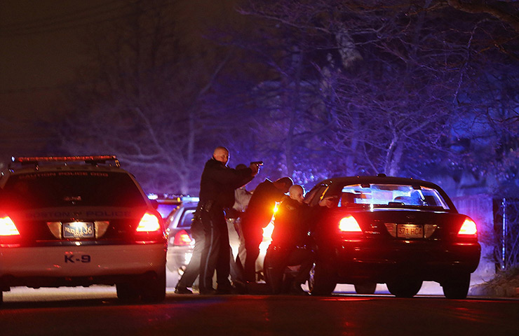 Boston bombings timeline: MIT Police Officers on with guns drawn on a college campus