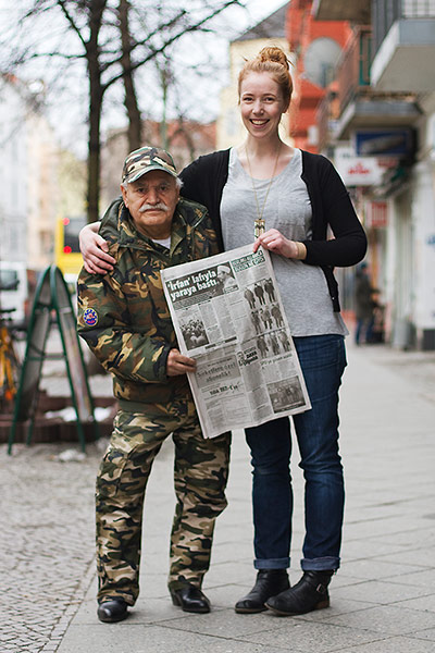 Big Picture - what ali: young woman standing next to middle eastern man holding newspaper