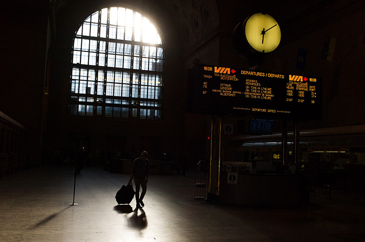 24 hours in pictures: A commuter walks through Union Station in Toronto, Canada