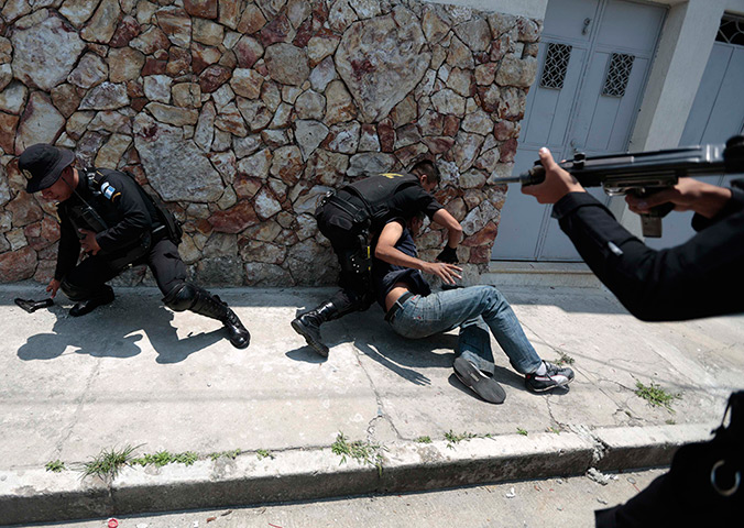 24 hours in pictures: Police officers capture a suspected hit man in Guatemala City