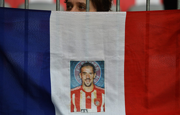 Bayern versus Barca: A fan holds a French flag with a photo of Franck Ribery