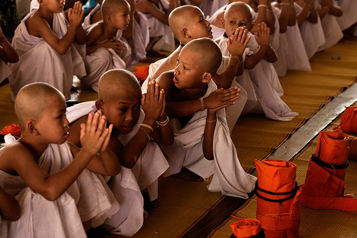 Theravada initiation: row boys white robes 