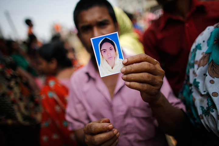 Building collapse: A relative holds a picture of a missing garment worker