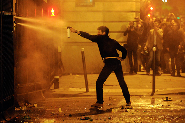 24 hours in pictures: Paris, France: An anti gay marriage protester uses tear gas during clashes 