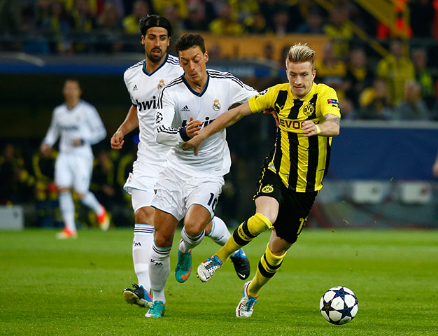 Dort v Real: Real Madrid's Khedira and Oezil challenge Borussia Dortmund's Reus