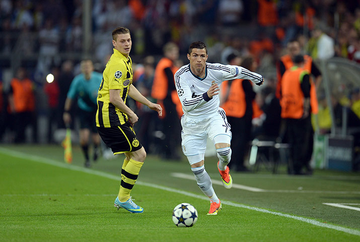 Dort v Real: Cristiano Ronaldo skipping past  Lukasz Piszczek