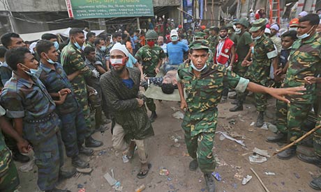A Bangladeshi garment worker pulled alive from the rubble of Rana Plaza is rushed to hospital