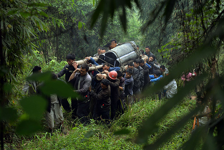 20 Photos: Villagers carry the coffin of a man kill