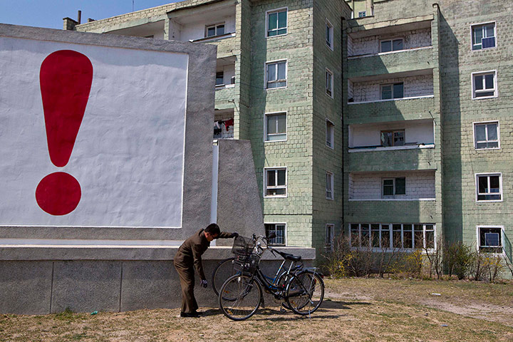 20 Photos: A North Korean man checks his bicycle in Kaesong