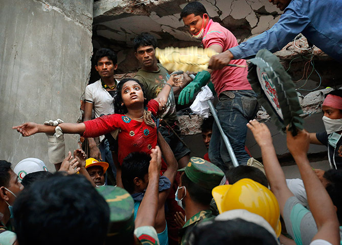 20 Photos: A Bangladeshi woman survivor is lifted out of the rubble