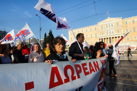 Protesters hold a banner during a protest rally, organized by the umbrella trade union groups General Confederation of Employees of Greece (GSEE) and the civil servants' union federation ADEDY, in front of the Greek Parliament in Athens, Greece, 28 April 2013.