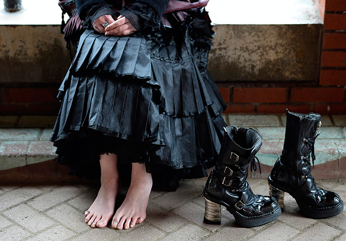 whitby goth festival: A woman sits rests her feet