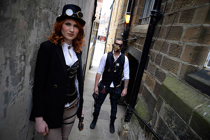 whitby goth festival: Goths pose for photographs in an alleyway