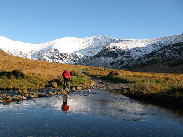 Your Pictures - Crossings: man dressed in red standing in middle of dramatic landscape