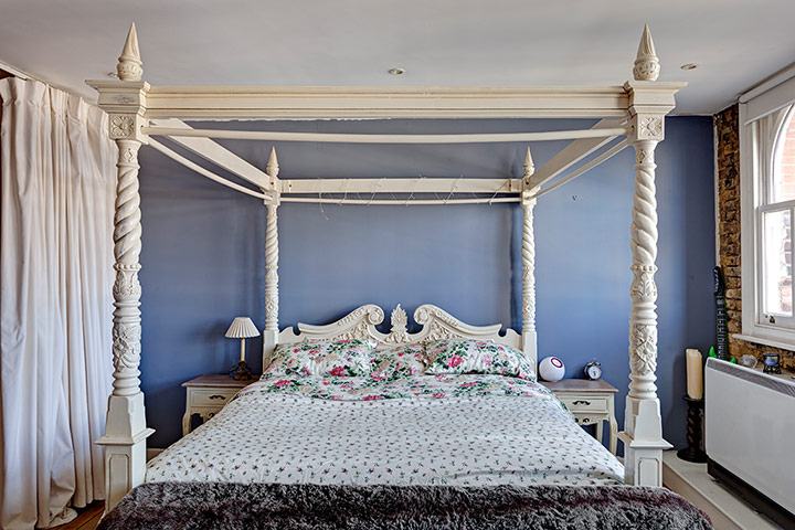 homes - attic: four poster bed against blue wall