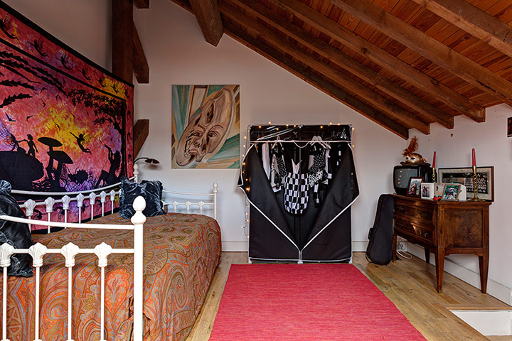 homes - attic: attic bedroom with red rug and wooden ceiling 