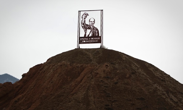 A Soviet era propaganda installation depicting Vladimir Lenin and reading 'Forward to the victory of communism!' is seen on a hill in the township of Kajy-Say, Kyrgyzstan. The population of the once bustling township has shrunk to about 2,500 from 15,000, its abandoned Soviet-built apartment houses gape with broken windows, and unemployed locals eke out a living by dismantling idle industrial buildings for construction materials.