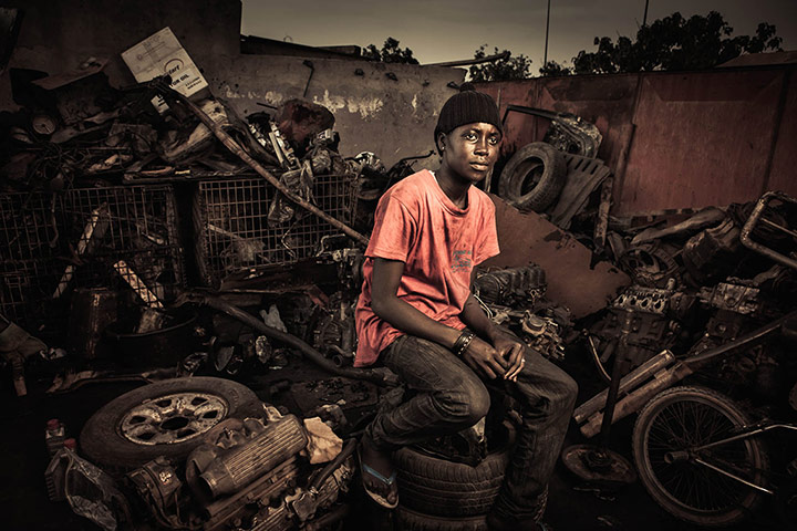 Big Picture - April 6: african woman in a garage dressed in pink 