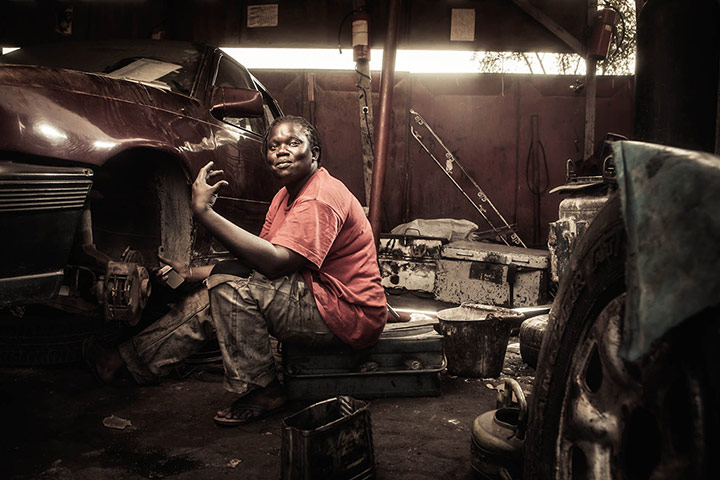 Big Picture - April 6: african woman dressed in pink sitting in a garage