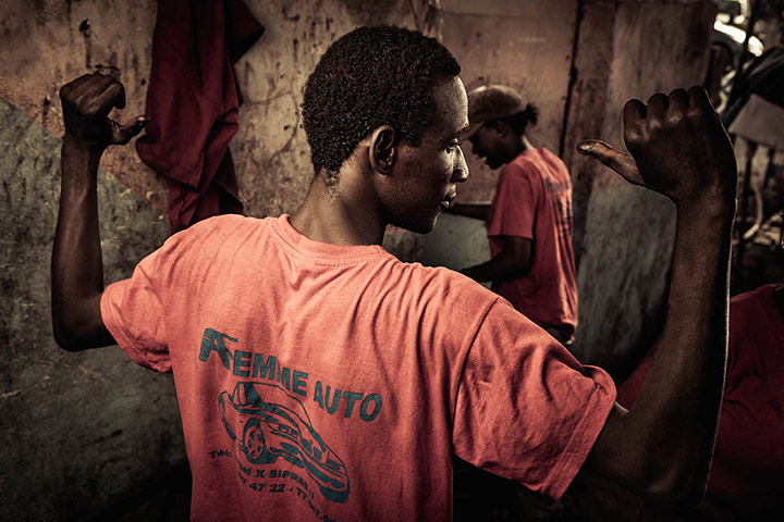 Big Picture - April 6: african man with pink t-shirt standing with hands up