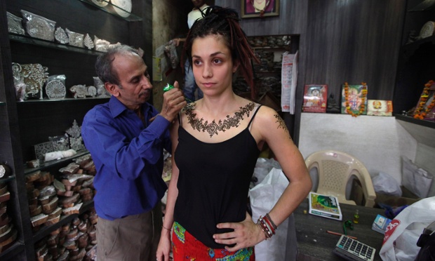 An Australian tourist gets a temporary henna tattoo at a shop in New Delhi, India. Violence against women, and the huge publicity generated by recent attacks here, is threatening India's $17.7 billion tourism industry. A new study shows tourism has plunged, especially among women, since a 23-year-old Indian student was raped on a New Delhi bus and later died from her injuries, a case that garnered worldwide publicity. Photograph: Manish Swarup/AP