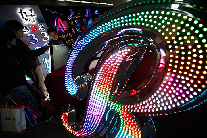 24 hours: Beijing, China: Visitors look at LED lighting products at the Beijing Inter