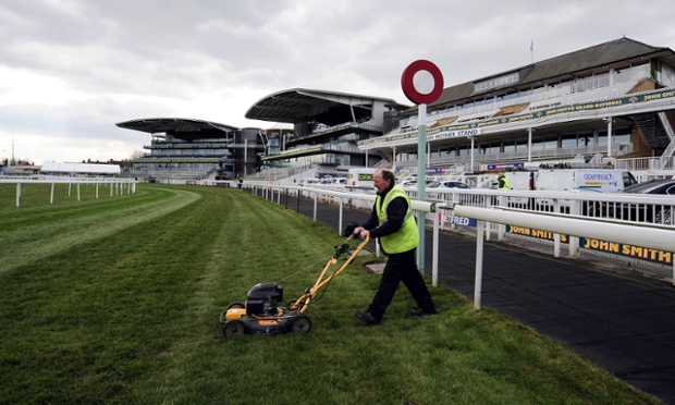 Man cuts grass shock! Some might say this smacks of PR desperation. The world famous finish line for the Grand National is cut by ground staff ahead of the 2013 John Smiths Grand National Meeting at Aintree Racecourse, Sefton, England.