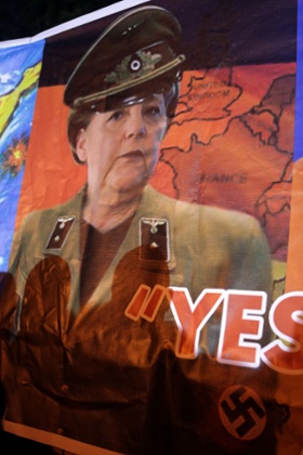 A poster depicting German Chancelor Angela Merkel as a Nazi officer, outside Cyprus presidential palace during a protest last week.