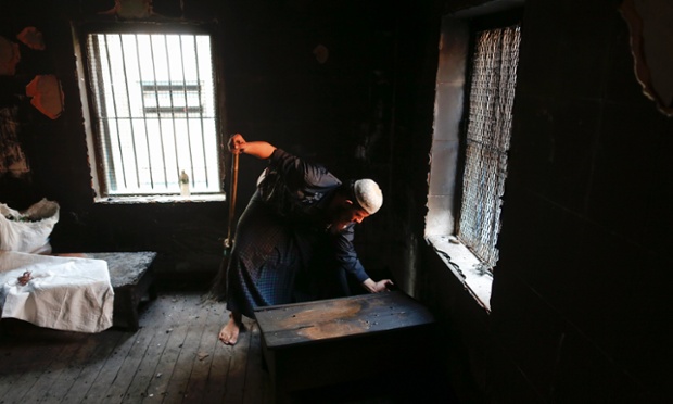 A Muslim man cleans the room of the Islamic school where 13 boys were killed by a fire caused by faulty electrical equipment in the Botataung district of Yangon, Myanmar.