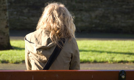 rear view young blonde woman sitting 