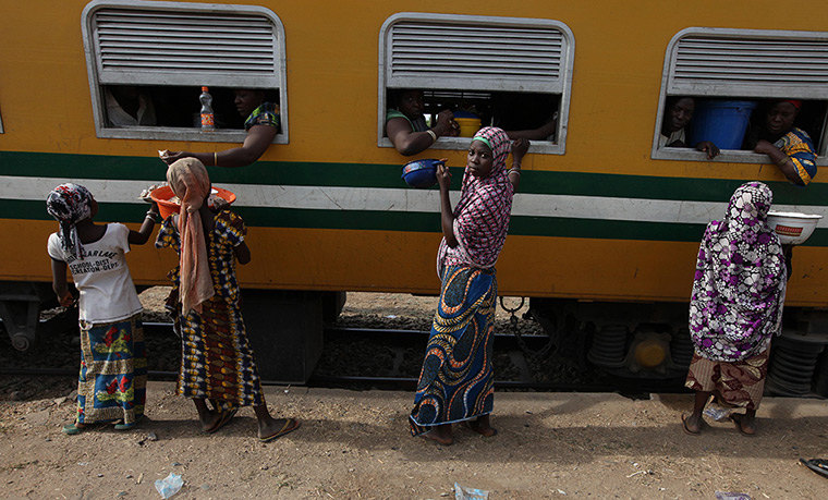 FTA: Sunday Alamba: Passengers aboard a train to Kano, buy drinks and water at a train terminal
