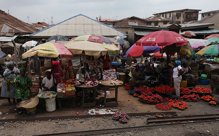 FTA: Sunday Alamba: People sell tomatoes and peppers alongside the railway line that runs Lagos