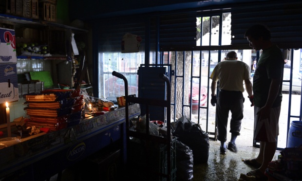 A worker walks out of a supermarket which was flooded and remains without electricity, in the neighbourhood of Belgrano, Buenos Aires, after torrential rain and strong winds battered the Argentine capital and its suburbs, knocking out power, downing trees and affecting 350,000 residents. At least eight people died in Buenos Aires after more than 155 mm of rain fell between midnight Monday and 7 am Tuesday.