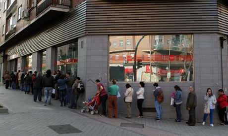 People queue outside an office to register for job placement in Madrid, Spain Thursday April 25, 2013.