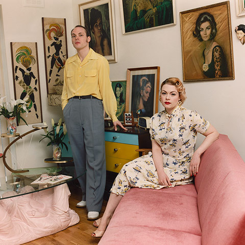 big pic - mods : mod couple sitting in room with pink sofa and artwork on walls