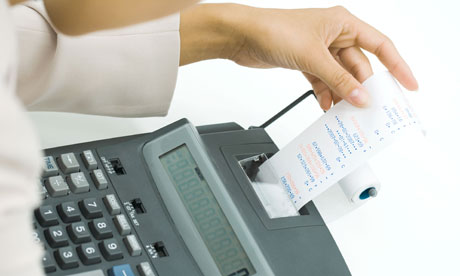 Businesswoman using adding machine