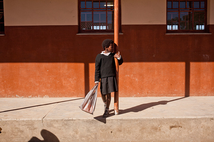 Eastern Cape Schools: A young school girl at Ntapane Junior Secondary School carries her lunch