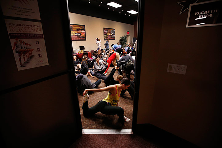 Radio City Christmas: Marie LeTourneau, of Bethlehem, Pennsylvania, warms up in a doorway as danc