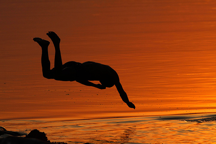 24 hours in pictures: Allahabad, India: An Indian boy jumps into the Ganges River