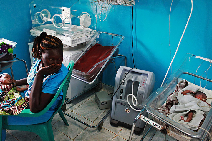 24 hours in pictures: Juba, South Sudan: A woman holds her newborn baby in a nursery at Juba