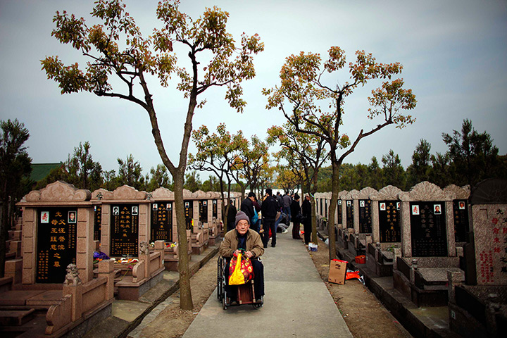 24 hours in pictures: Shanghai, China: An elderly man sits on a wheelchair as he visits a cemeter