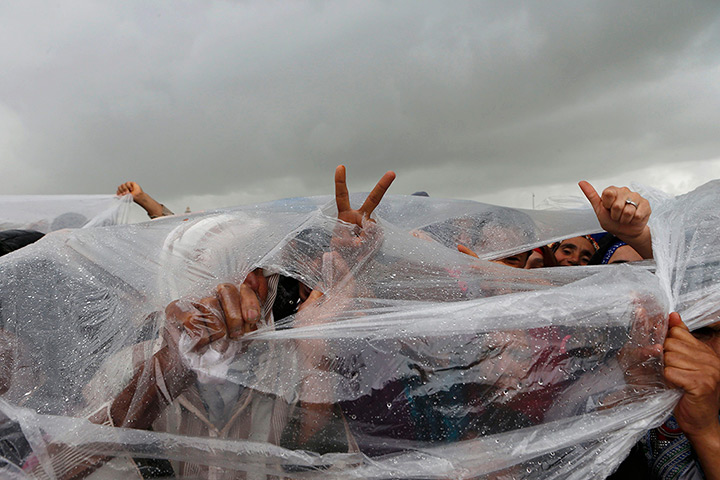24 hours in pictures: People take cover as they wait for Morocco's King Mohammed VI